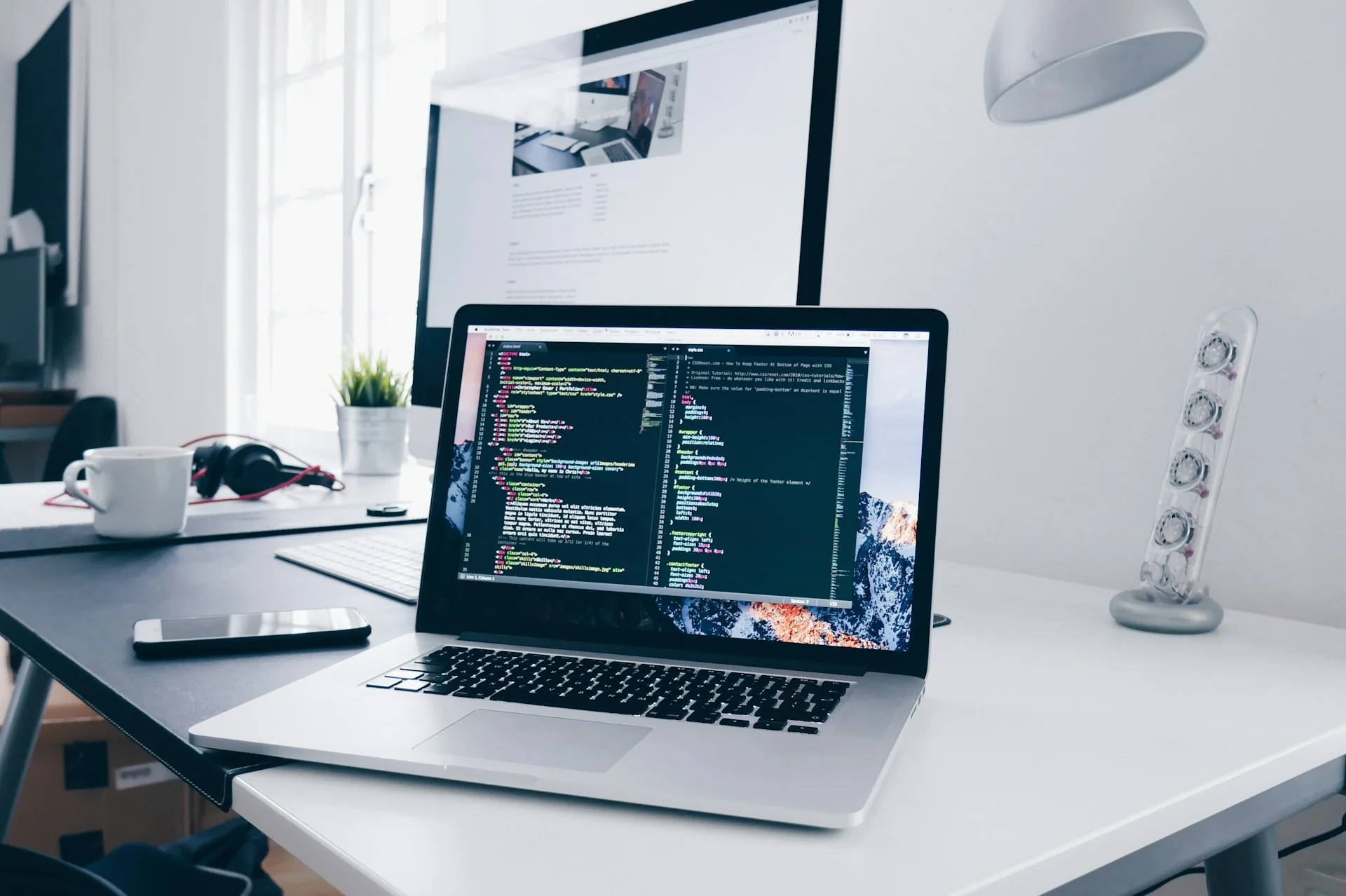 Bright laptop workspace displaying software code
