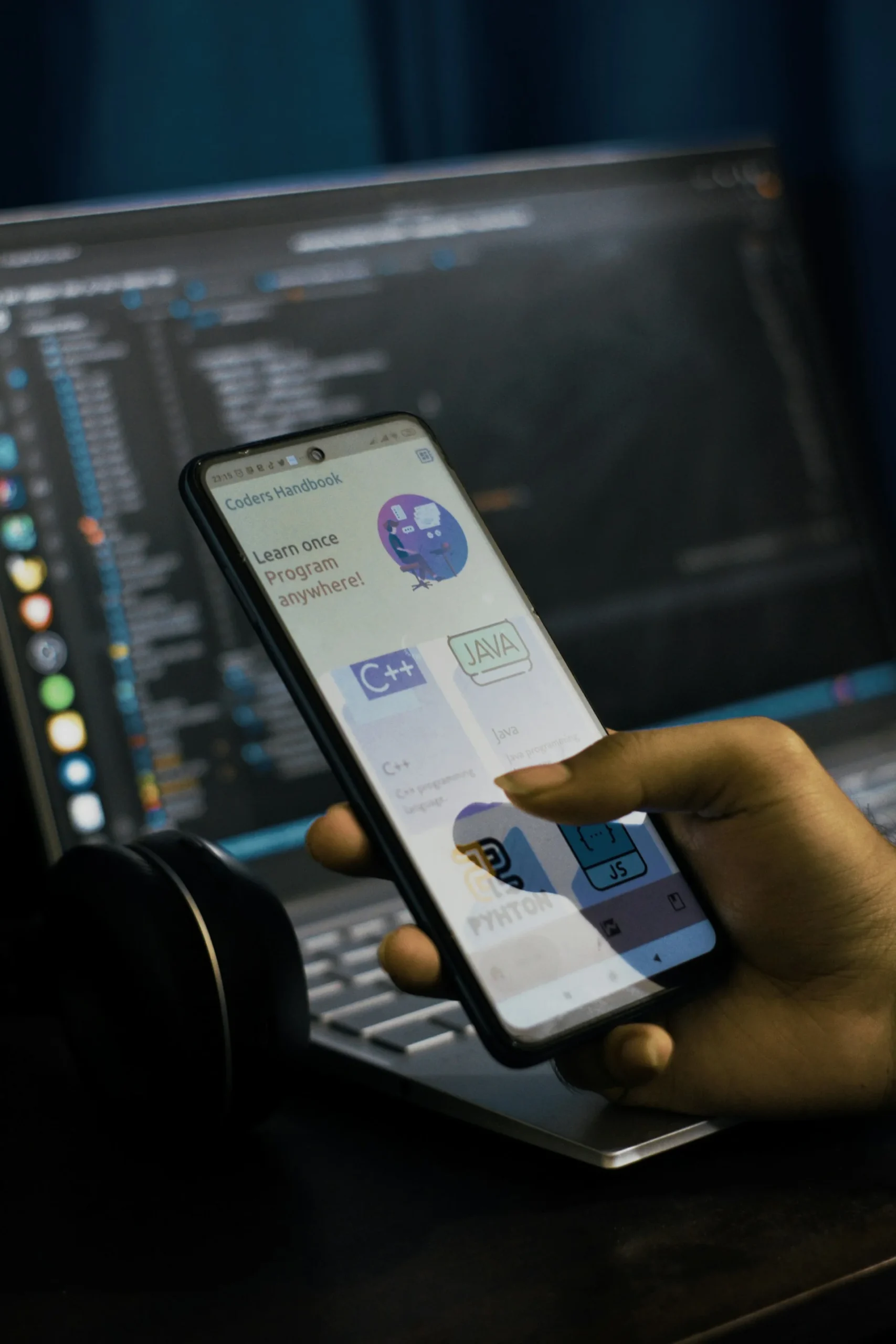 Smartphone positioned against a software code background