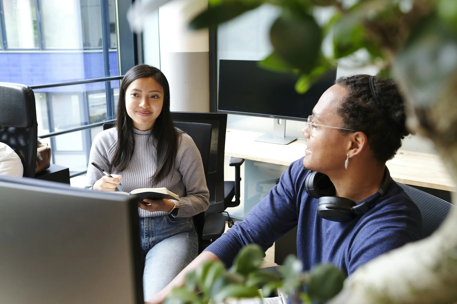 Colleagues discussing a digital product in an office